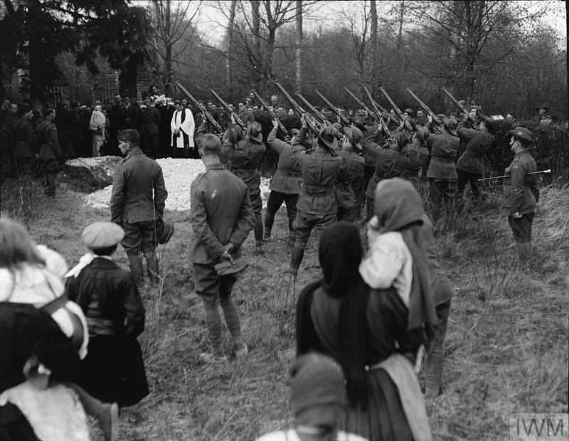 Australian troops firing a gun salute at Baron von Richthofen's funeral, Bertangles Cemetery.